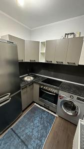 a kitchen with a refrigerator and a washer and dryer at Apartment for rent in Căușeni 2 in Căuşeni