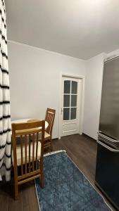 a kitchen with a table and chairs and a refrigerator at Apartment for rent in Căușeni in Căuşeni