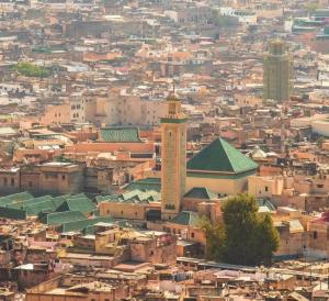 an aerial view of a city with a tall building at Riad Fes Madaw in Fez