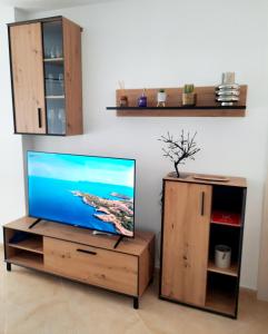 a flat screen tv sitting on a wooden entertainment center at CASA PEPA in Guadalest