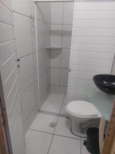 a small bathroom with a toilet and a sink at Casa em Paracuru a 5 minutos (de carro) do centro. in Paracuru