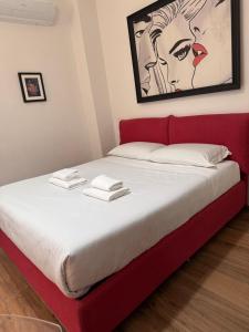 a bed with a red headboard in a room at Il Violino in Florence