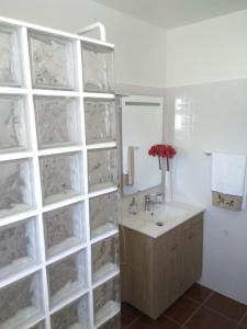 a bathroom with a sink and a wall with a mirror at Sunrise Holidays in Porto Santo