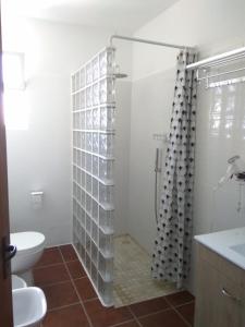 a bathroom with a toilet and a shower at Sunrise Holidays in Porto Santo