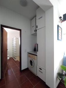 a kitchen with a washer and dryer in a room at Sunrise Holidays in Porto Santo