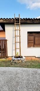 a wooden ladder in front of a house at 7Pines Bijambare - Air Spa in Sarajevo