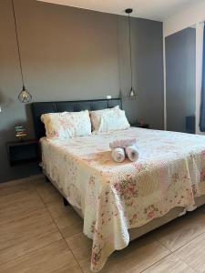 um quarto com uma cama com dois bichos de peluche em Cantinho Feliz - Próximo ao Centro histórico em Tiradentes