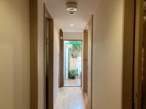 a hallway with a door leading into a house at Santana Guest House Kyoto in Kyoto