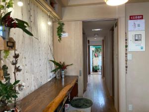 a hallway with a wooden bench in a room at Santana Guest House Kyoto in Kyoto