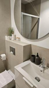 a bathroom with a sink and a mirror at Villa Neptun Apartament nad morzem Gdańsk Wyspa Sobieszewska in Gdańsk