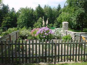 ノイシェーナウにあるFerienwohnung Späthの花の咲く庭の前の柵