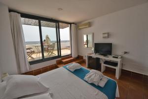 a bedroom with a bed and a desk and a window at Calachica Las Negras Hotel Boutique in Las Negras +123 photos