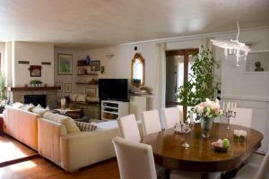 een woonkamer met een bank en een tafel bij Villa Carla Piemonte private pool in Melazzo