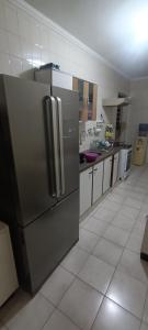 a kitchen with a stainless steel refrigerator in it at Casa completa in Marília