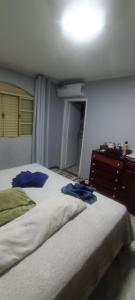 a bedroom with two beds and a dresser in it at Casa completa in Marília