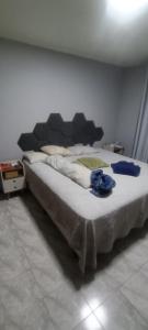 a large bed sitting in a room with at Casa completa in Marília