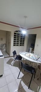 a kitchen with a table and chairs in a room at Casa completa in Marília