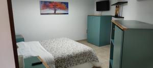 a bedroom with a bed and a tv in a room at Dimora Nonna Angela in Alberobello