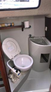 a small bathroom with a toilet in an rv at Yacht & Breakfast in Bergen