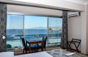 a hotel room with a view of the ocean at Perla Hotel in Dikili