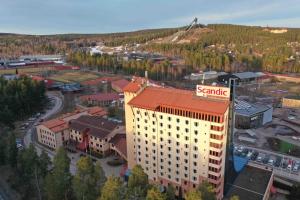 a large building with aenna sign on the top of it at Scandic Lugnet in Falun