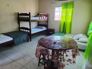 a room with two bunk beds and a table at Casa Alter do Chão Natureza in Alter do Chao