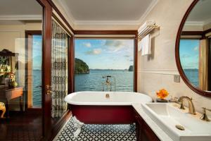 a bathroom with a tub and a view of the water at Emperor Cruises Legacy Ha Long in Ha Long +37 photos