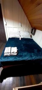 a bed with towels on it in a room at Chalé das Margaridas in Rio Forcação +35 photos