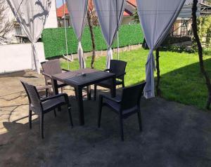 a table and four chairs and a table and a table and chairs at FIA HOUSE Kozle in Ždanec