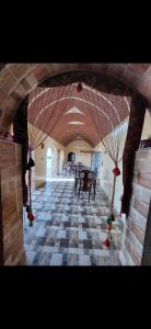 Habitación grande con mesa y suelo de tablero de ajedrez. en Nuba life Mostafa Guesthouse, en Najâ€˜ al MadÄbb