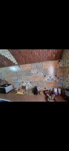 Cette chambre est dotée d'un mur carrelé et d'une table avec de la nourriture. dans l'établissement Nuba life Mostafa Guesthouse, à Najâ€˜ al MadÄbb