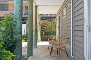 a patio with two chairs and a building at Urban Apartment in the Heart of Paddington in Brisbane