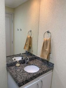 a bathroom with a sink and a mirror at Apartment Neo 2.0 in Maceió