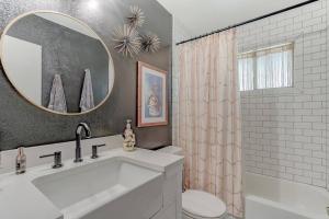 a bathroom with a sink and a toilet and a mirror at Cheerful 1-Bedroom Lake Cottage in Lakehead