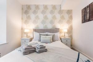 a bedroom with a bed with towels on it at Deansgate Luxury Apartments in Manchester