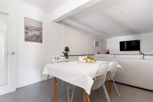 a white dining room with a white table and chairs at Hadspen Riverview Retreat: 2 Bedroom Unit in Hadspen