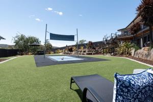 a large lawn with a bench and a flag at Hadspen Riverview Retreat: 2 Bedroom Unit in Hadspen
