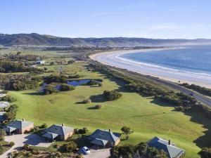 an aerial view of a beach with houses and the ocean at Apollo Bay Cottages- Marriners in Marengo