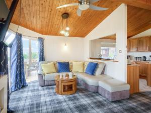 a living room with a couch and a table at Cabin Retreat in Skelmorlie