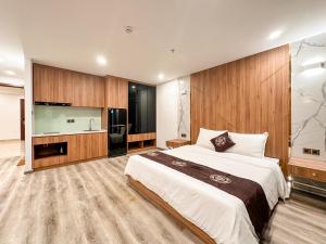 a large bedroom with a large bed and a kitchen at DA NANG BAY HOTEL in Danang