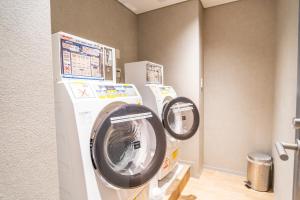 a washer and dryer in a room at Travelodge Kyoto Shijo Kawaramachi in Kyoto