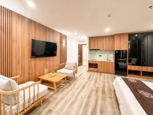 a room with a bed and a tv and a kitchen at DA NANG BAY HOTEL in Danang