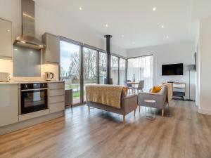 a kitchen and living room with a table and chairs at The Haywain in East Bergholt
