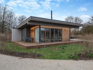 a small house with a deck in a field at The Haywain in East Bergholt