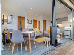 a kitchen and living room with a table and chairs at The Haywain in East Bergholt