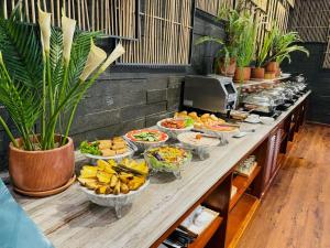 a buffet with bowls of food on a table at Luu Ngai Condotel Quy Nhon in Quy Nhon