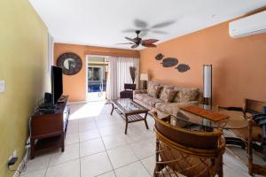 a living room with a couch and a table at Gardenia Suite located across from beach in a boutique property in Kihei