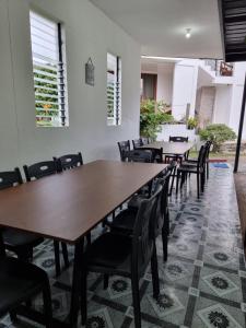 a row of tables and chairs in a room at The Boathouse at Calatagan in Sipating