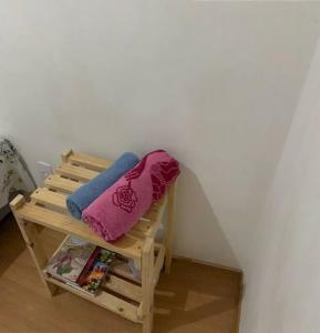 a wooden bench with two pillows on top of it at Ap proximo ao Aeroporto e ao Shopping Pátio Maceió in Maceió