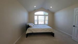 a bedroom with a small bed with a window at Family friendly home, amazing view in Dallas